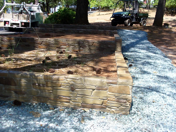 A rock layered garden retaining wall.